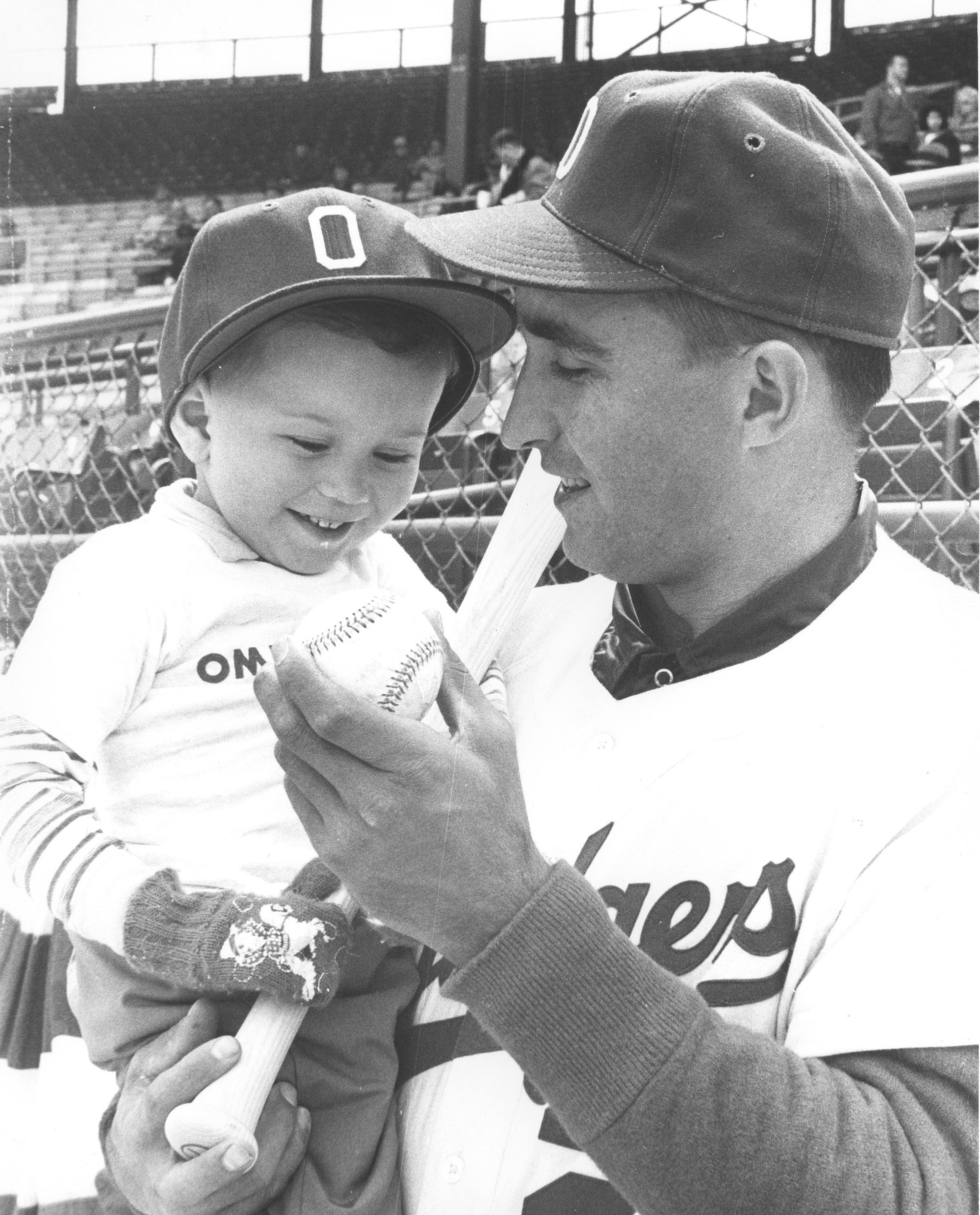 Frank Gahl as a child on the field with Omaha Dodgers player; photographer’s field photo (1961)