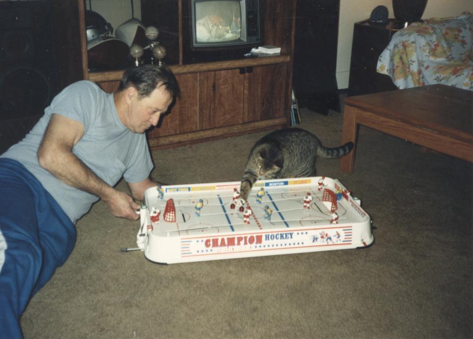 Charm nudging a puck toward Dad’s goal on the board hockey game